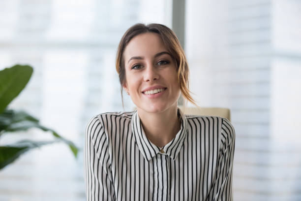 istockphoto-1129638608-612×612 Smiling businesswoman looking at camera webcam make conference business call, recording video blog, talking with client, distance job interview, e-coaching, online training concept, headshot portrait